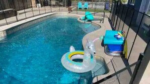 A swimming pool with inflatable rings and lounge chairs. - Oceanside Gem W/ Pool, Hot Tub and Game Room! (Oceanside)