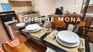 A modern kitchen with a dining area set for a meal. - The 5 Schei De Mona Circuit is The Unique Widespread Concierge Service in Venice (Venezia)