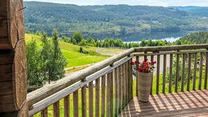 A wooden balcony with a view of a lake and hills. - Lindefjeldbu by Interhome (Eikerapen)