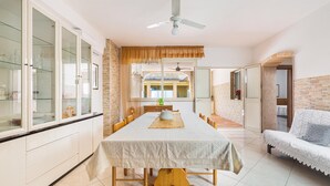 A spacious dining area with a long table, chairs, and a ceiling fan. - 2907 Casa la Terrazza by Barbarhouse (Manduria)