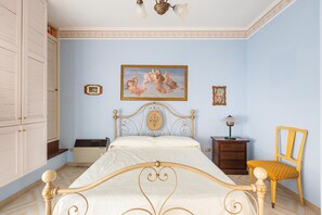 A bedroom with a bed, a chair, a nightstand, a dresser, and a painting on the wall. - 2795 Casa Palma by Barbarhouse (Maruggio)