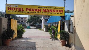 The entrance to Hotel Pavan Mansion, featuring a prominent sign with the hotel's name and description. - Hotel Pavan Mansion (Raichur)