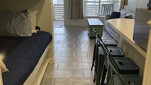 A compact room with bunk beds, a kitchenette, and a balcony with a view of buildings. - Oceanside, steps to the Beach, pets considered, cards avail, Beach Club Complex (Saint Helena Island)
