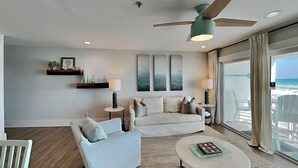 A modern living room with a sofa, armchairs, a coffee table, and a ceiling fan. - Luxe Gulf Front Condo, Stunning Views. Community Pool (Santa Rosa Beach)