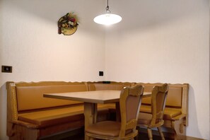 A dining area with a table and bench seating.