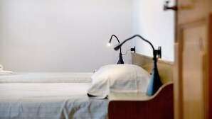 A bedroom with a single bed, a bedside table, a lamp, and a nightstand. - Holiday Apartment "Casa Marcos n 31" with Mountain View, Balcony & Wi-Fi (Livigno)