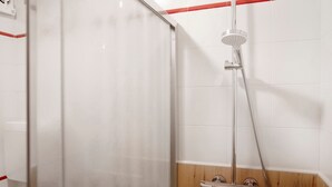 A shower enclosure with a glass door, a handheld showerhead, and a wall-mounted faucet. - Holiday Apartment "Casa Marcos n 32" with Mountain View, Balcony & Wi-Fi (Livigno)