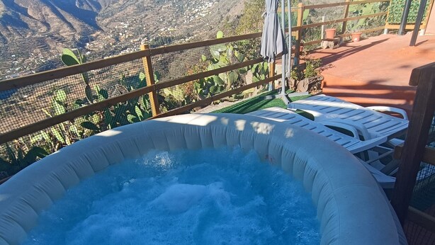An inflatable hot tub with a mountain view.