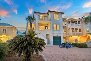 A multi-story residential building with a balcony, a driveway, and bicycles parked outside. - Gulf View Home | Steps to Beach Access (Santa Rosa Beach)