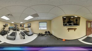 A 360-degree view of a gym with treadmills, elliptical machines, and free weights. - Ambridge Inn (Ambridge)