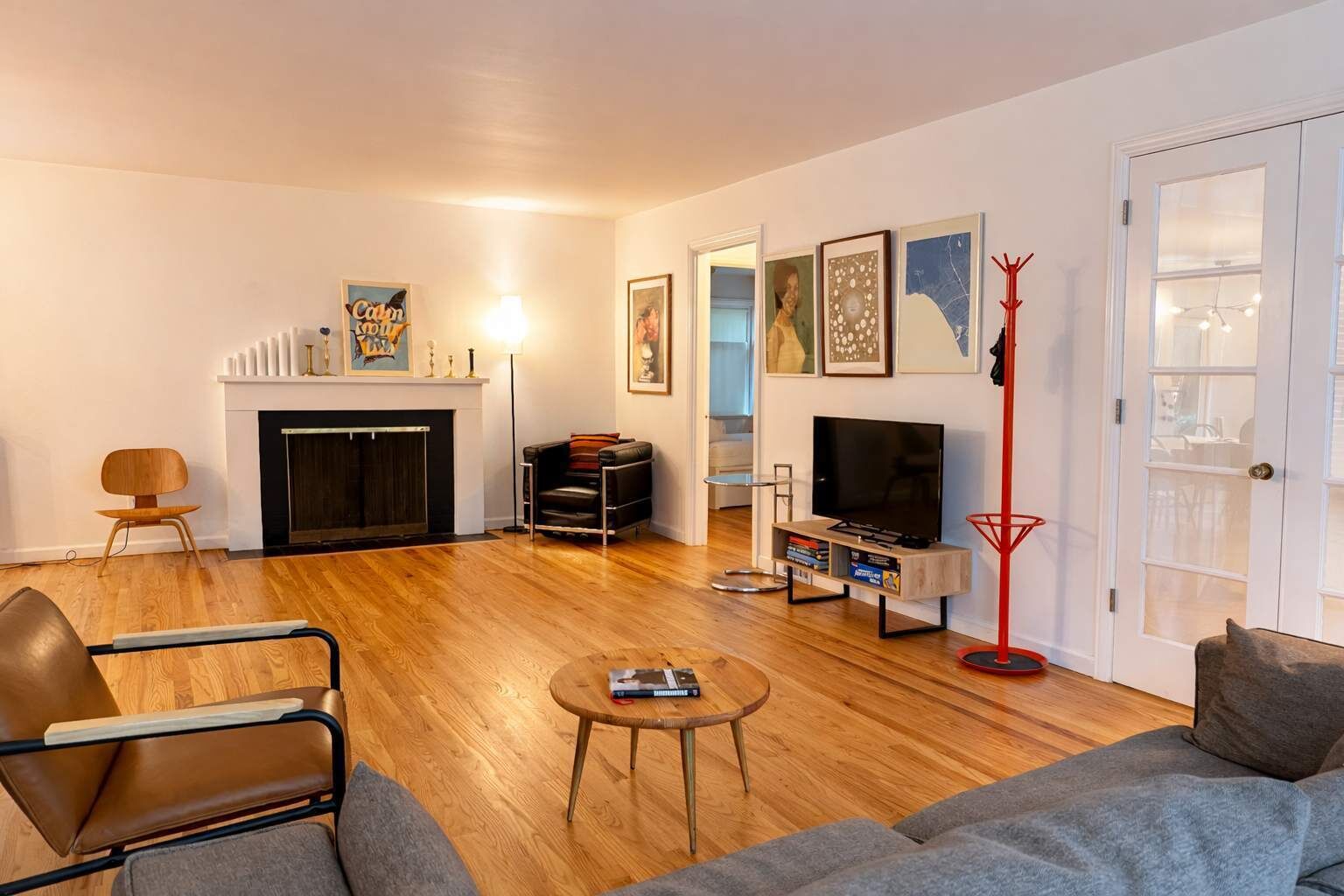 A living room with a fireplace, a television, and a bookshelf.