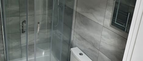 Apartment, Multiple Beds | Bathroom | Combined shower/bathtub, deep-soaking bathtub, towels, soap