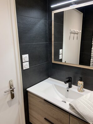 Bathtub, hair dryer, towels, soap