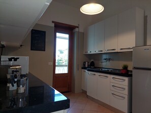 Fridge, microwave, stovetop, coffee/tea maker