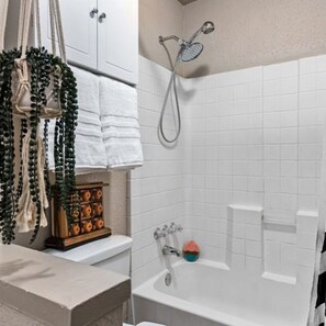 Bathtub, hair dryer, towels, soap