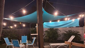 An outdoor deck with lounge chairs and a canopy. - New on Market ! Beautiful family home close to beach, golf, tennis and shopping. (Venice)