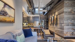 A modern interior with a sofa, coffee table, and dining area. - Outpost: Pearl at Jackson - Close to Town Square (Jackson)