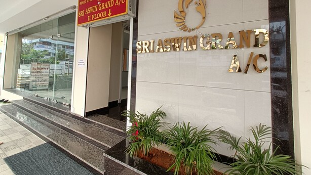 The entrance of Sri Aswin Grand A/C with a sign indicating the location on the II floor. - Sri Aswin Grand (Namakkal)