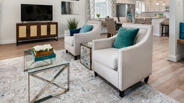 A spacious living room with a flat-screen TV, a glass coffee table, and a sofa with teal cushions. - Super Cozy Entire House. Close to Everything (Katy)