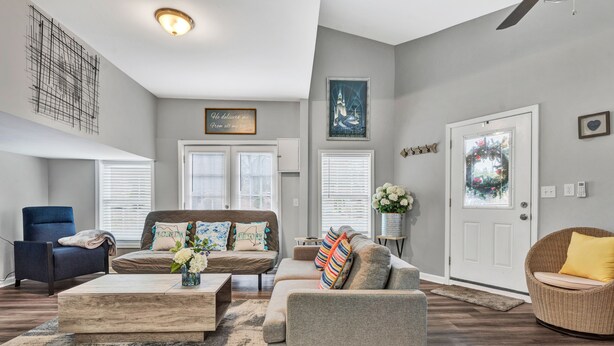 A living room with a sofa, armchairs, a coffee table, and a fireplace. - Beautiful Renovated Lake Cottage in SW County and only minutes from Downtown! (Roanoke)
