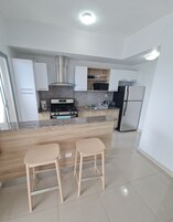 Comfort Apartment | Private kitchen | Full-size fridge, microwave, oven, stovetop