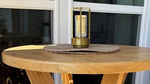 A round wooden table with a central candle holder, surrounded by four wooden chairs. - Newly Remodeled. Water views from your private lanai.  Steps to Madeira Beach. (Madeira Beach)