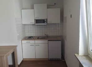 Eenvoudige studio | Privékeuken | Een koelkast met diepvriezer, een microgolfoven, een kookplaat