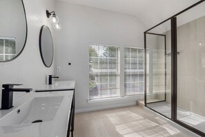 Bathtub, hair dryer, towels, toilet paper