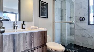 Signature Apartment | Bathroom | Shower, rainfall showerhead, hair dryer, towels