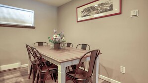 A dining room with a rectangular table, six chairs, a potted plant, and a framed picture on the wall. - 6 bedroom, 2 kitchens, 2 dining room home with large backyard in quiet area (Coquitlam)