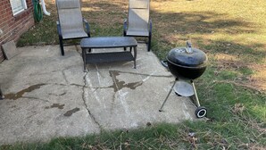 A patio with two chairs, a small table, and a barbecue grill. - Quiet and Cozy Home in the Heart of Southaven (Southaven)