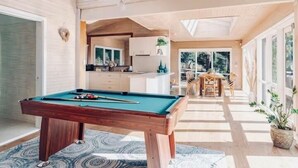 A pool table in a room with wooden walls and a skylight. - Villa with Spa and Breathtaking Views of Dandenong Ranges (Kalorama)