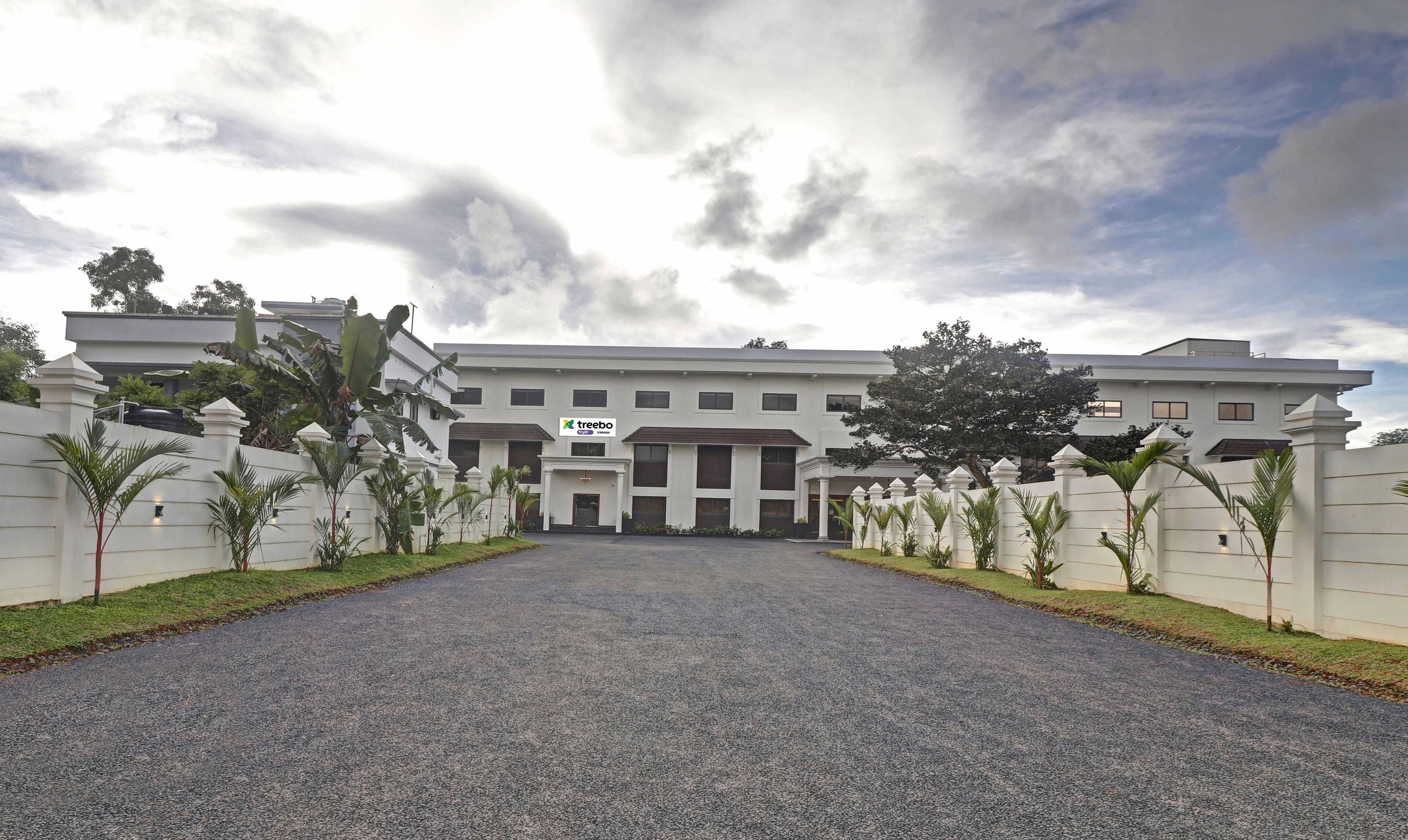 A large, modern building with a sign for 'Treebo'.