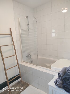 Enjoy a refreshing shower or soak in the bathtub in this clean and minimalist bathroom.