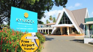 A sign for Kynrock Hotels & Resorts with a 'Free Airport Transfer' offer. - KYNROCK Airport Hotel (Seeduwa - Katunayake)