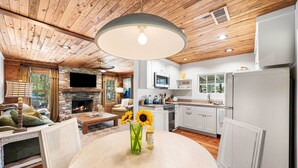 A modern kitchen with white cabinets, a built-in microwave, and a refrigerator.