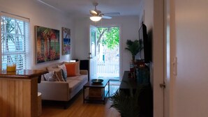 A living room with a sofa, coffee table, and artwork on the walls. - Casa Louisa -Beautiful 2 Bedroom in Old Town - Right off Duval/Great Front Porch (Key West)