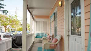 A porch with wicker chairs and a covered car. - Casa Louisa -Beautiful 2 Bedroom in Old Town - Right off Duval/Great Front Porch (Key West)
