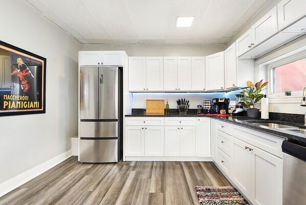 Enjoy cooking in this well-equipped kitchen with a refrigerator, coffee maker, and ample countertop space.