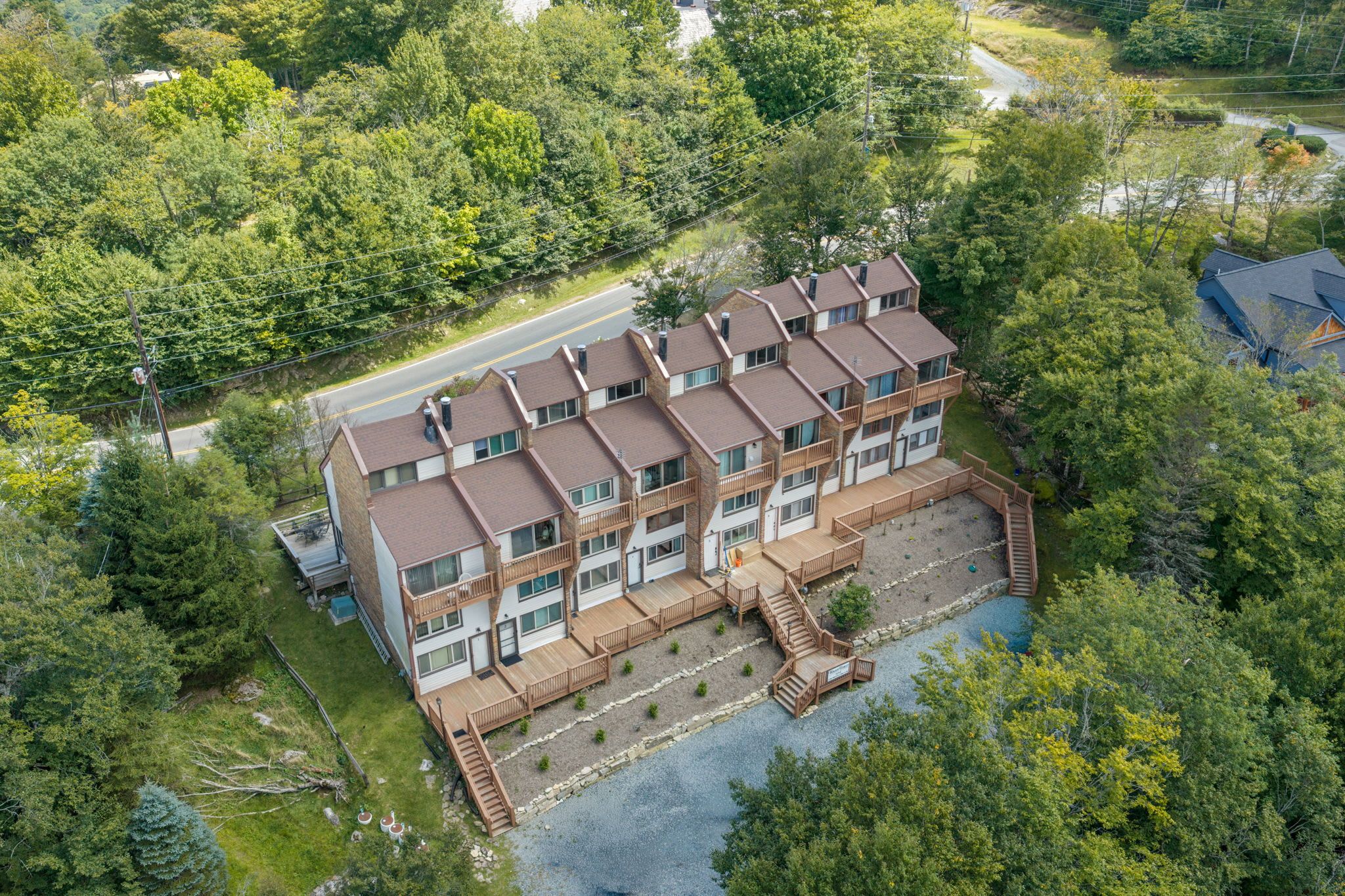 A multi-story building with a central courtyard, surrounded by dense greenery.