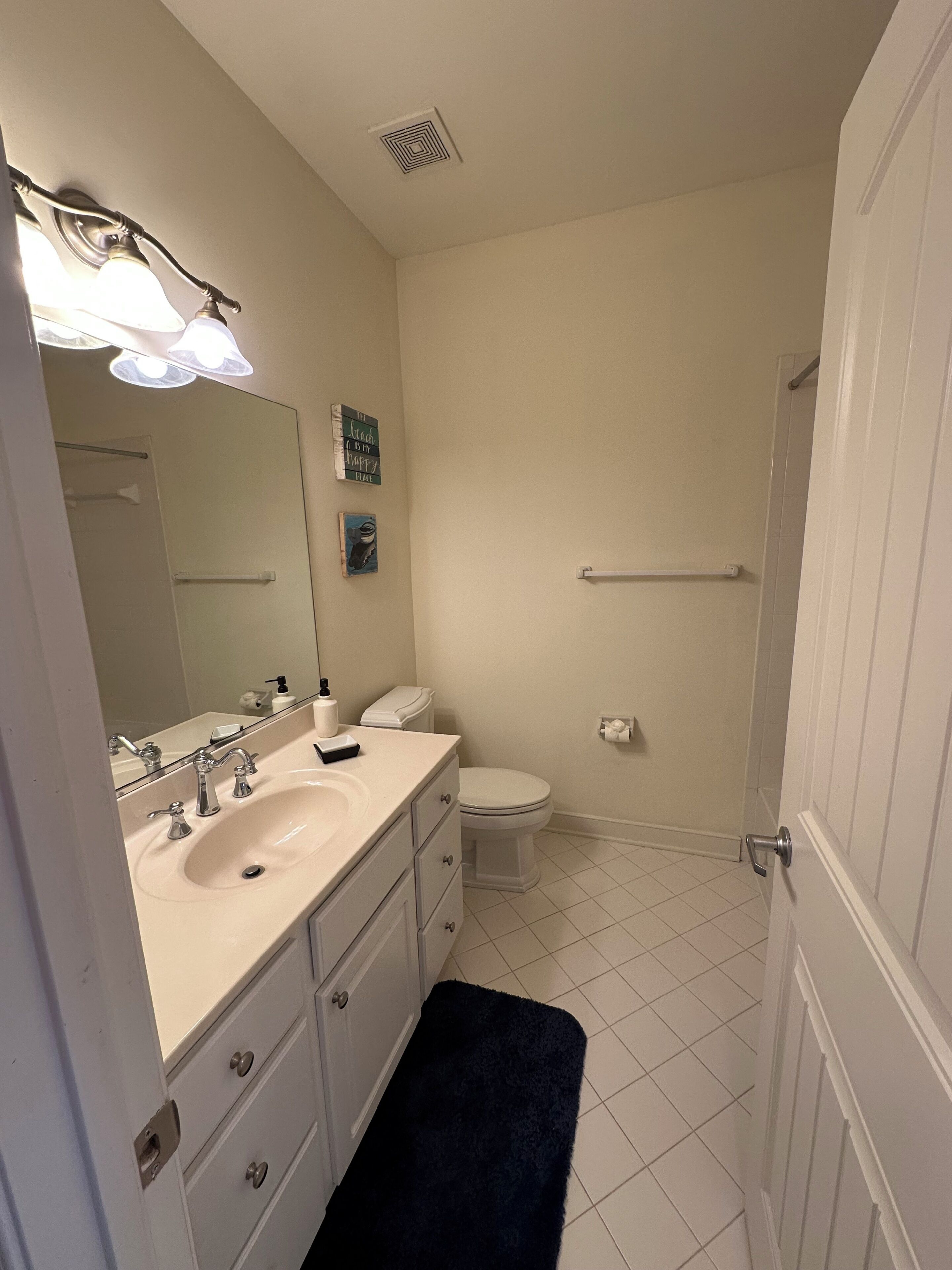 A bathroom with a sink, toilet, and shower.