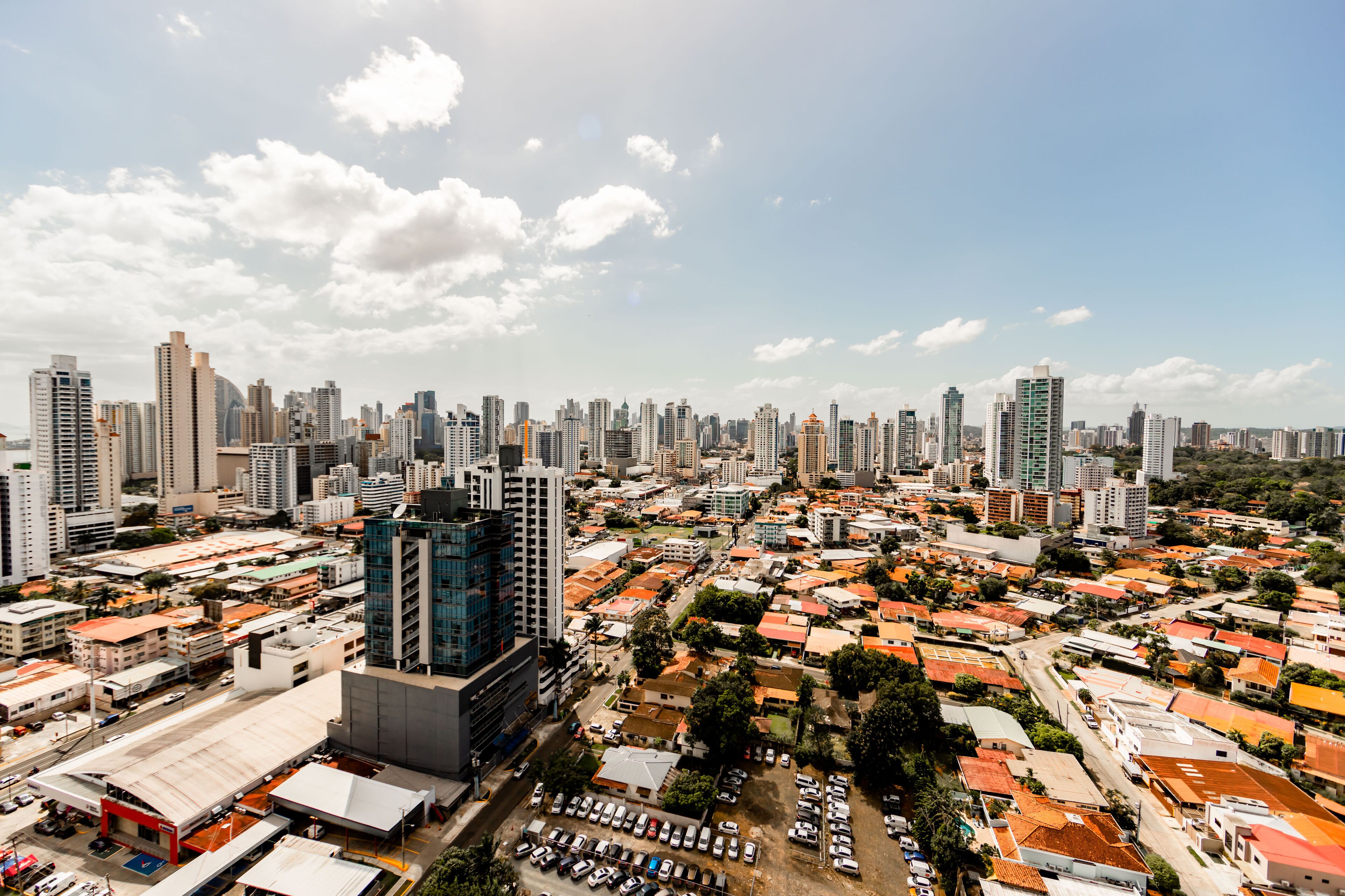 A cityscape with high-rise buildings, a mix of residential and commercial structures, and a clear sky.