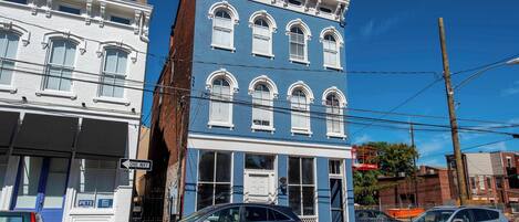 A two-story building with a blue facade and white trim.
