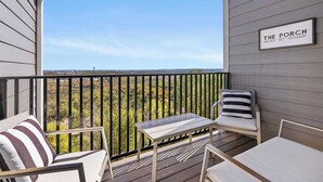 A balcony with a view of trees and a sign that reads "THE PORCH RELAX - SIT - GOSSIP". - A Little Slice of Branson - Ozarks Views (Branson)