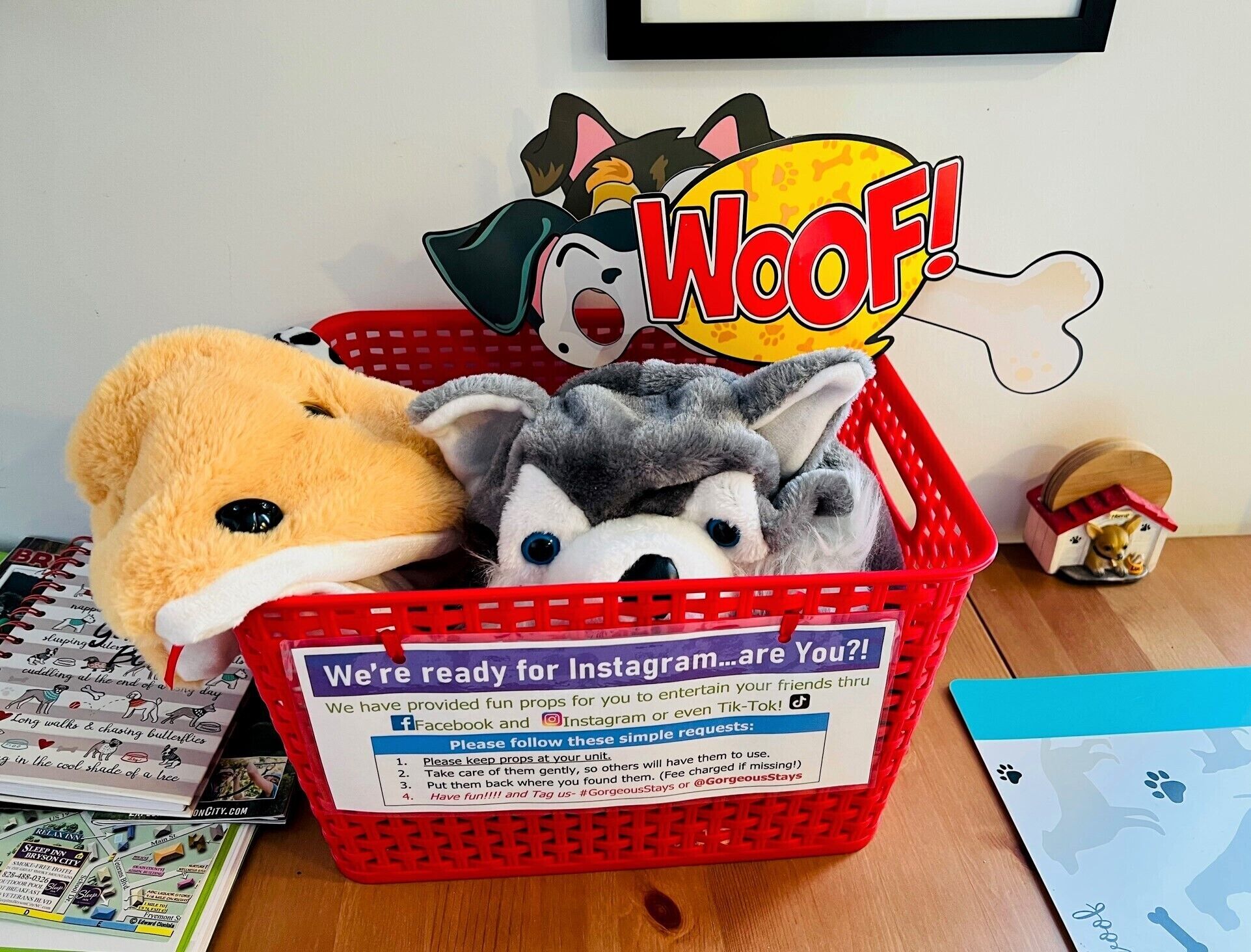 A red basket filled with plush toys and a sign promoting Instagram.