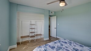 A bedroom with a bed, a ceiling fan, a white wardrobe, and a wooden ladder. - Discover Micco charm, just a quick 23-min drive to Wabasso Beach Park (Micco)