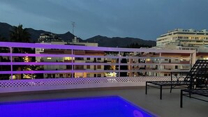 A rooftop pool area with a view of buildings and mountains in the background. - Pent-House, 3 Bedroom, Sleeps 6, Parking (Marbella)