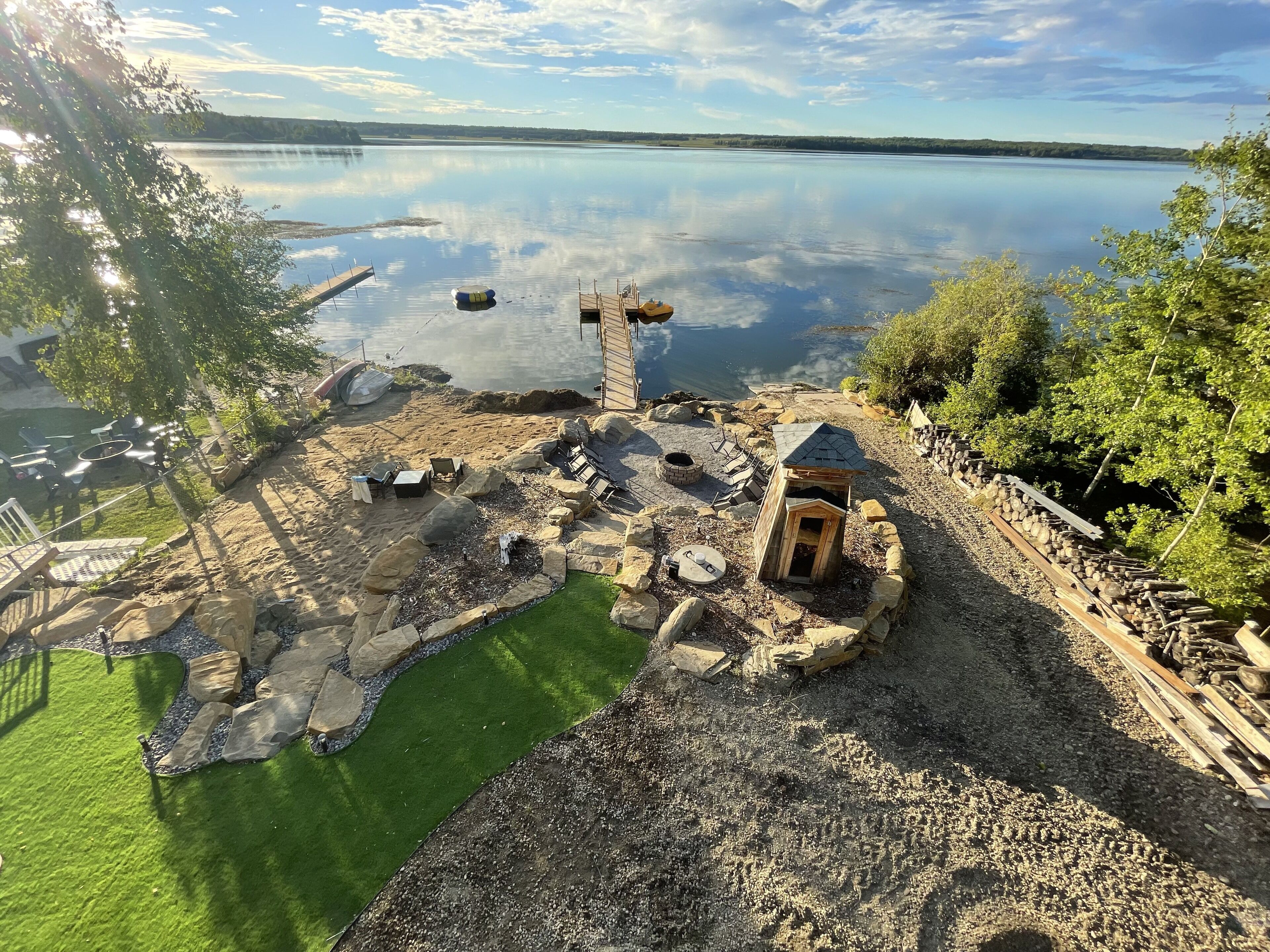 Back yard, private beach, private small boat launch, synthetic grass play area. 