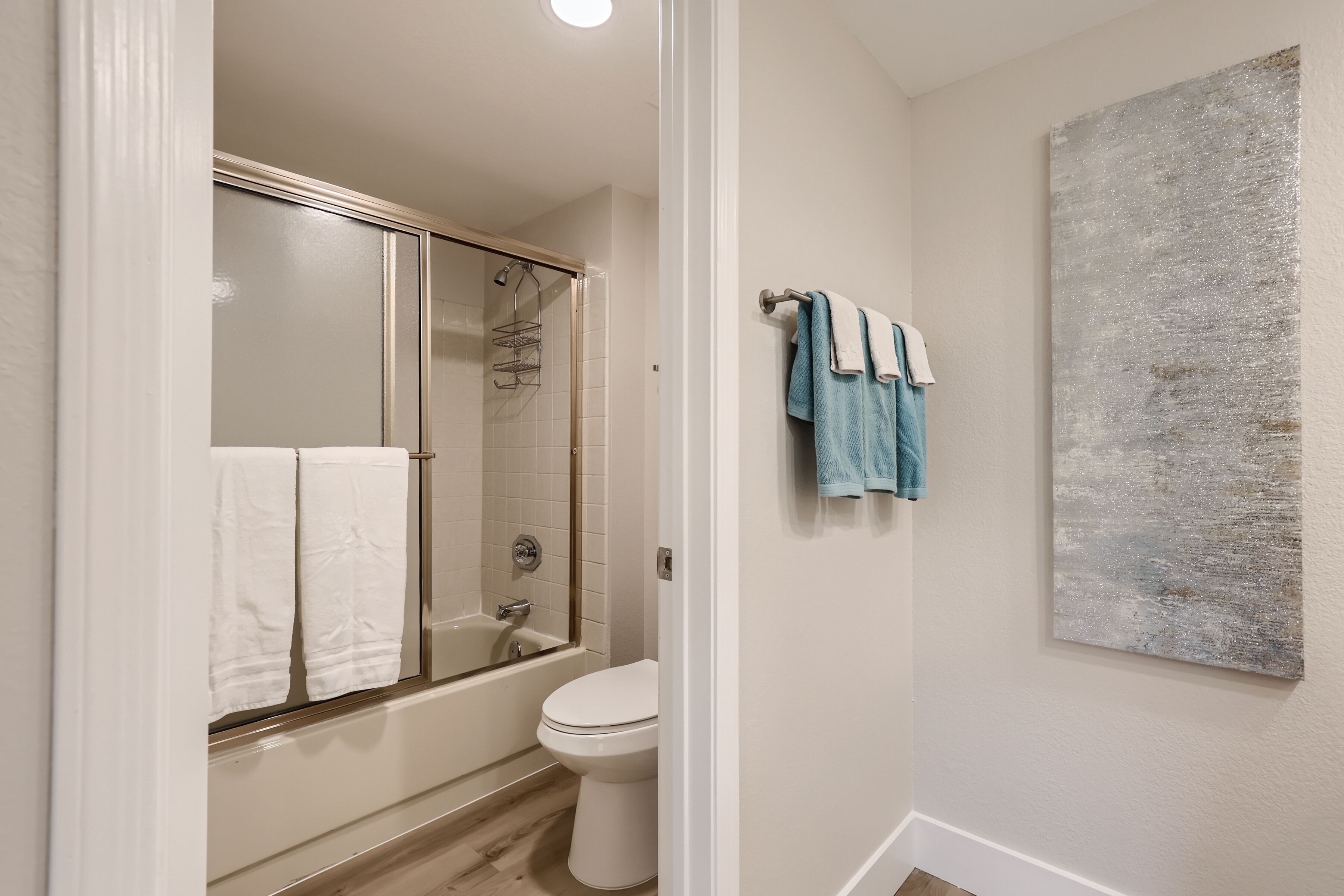 Un baño con bañera, inodoro y cabina de ducha de vidrio.