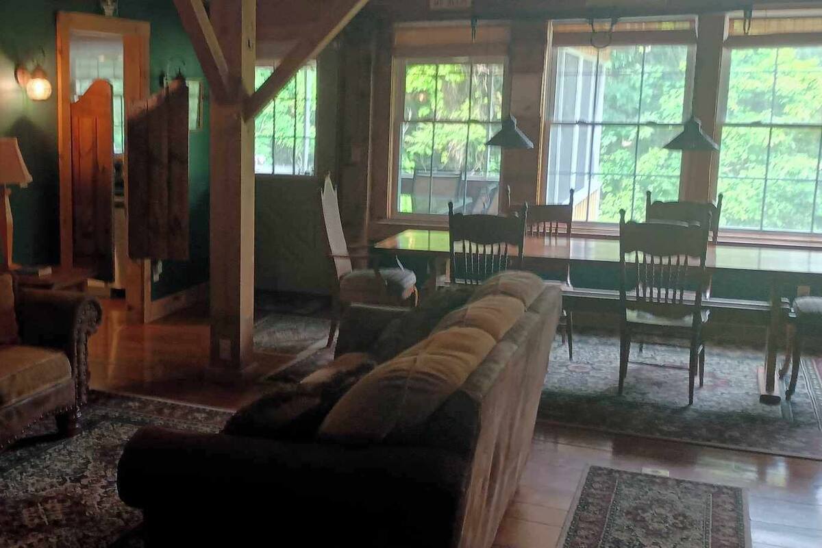 A cozy living room with a sofa set, a coffee table, and a fireplace.